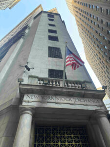 A drone flying around the New York Stock Exchange, performing a building inspection